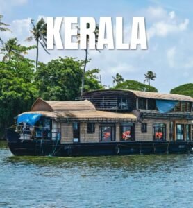 Traditional Kerala houseboats floating on tranquil backwaters, surrounded by lush greenery and palm trees.