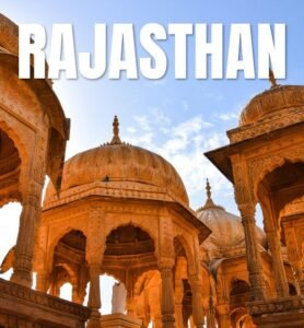 A scenic view of Rajasthan's desert landscape, showcasing sand dunes and traditional architecture in the background.